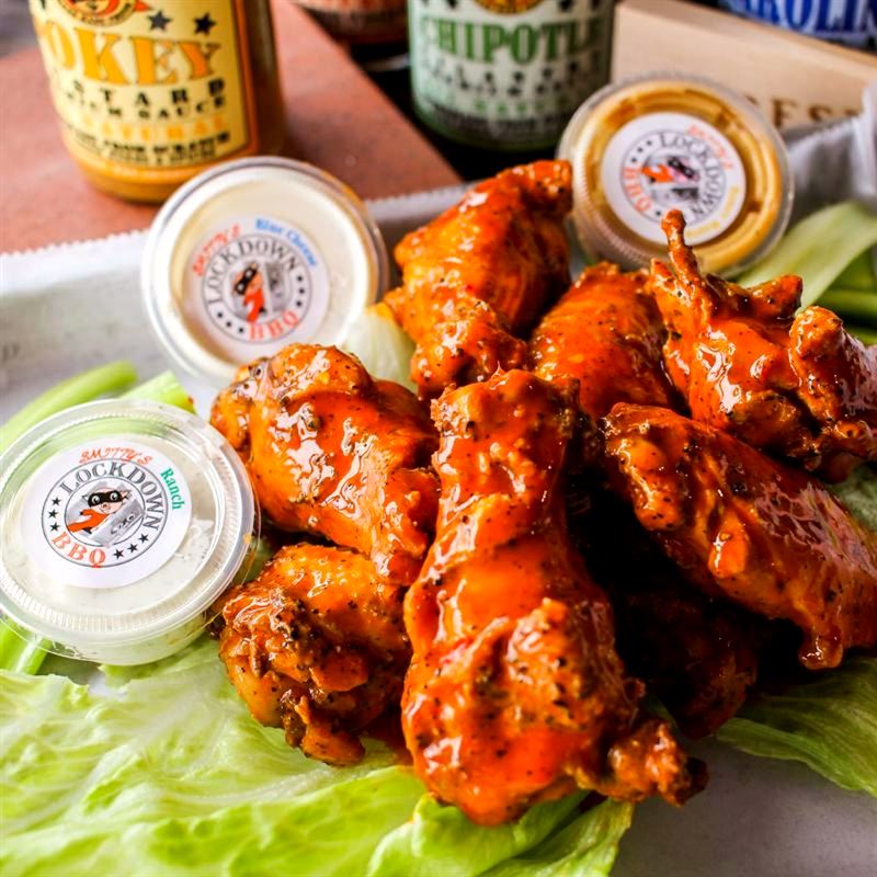 Fried wings tossed in buffalo sauce with house sauces on the side